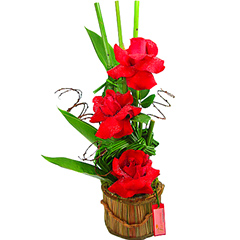Maravilhoso trio de rosas colombianas enfeitado com junco, vime e folhagens.